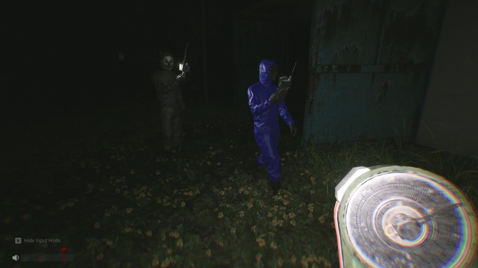 An agent with a scanner moves through the dark woods as figures linger behind
