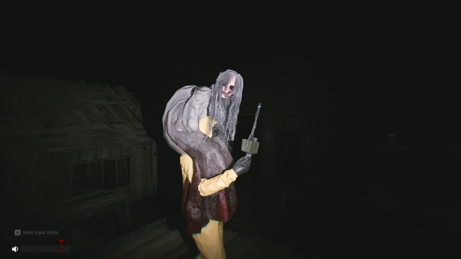 A pale figure stands in the darkness behind an agent